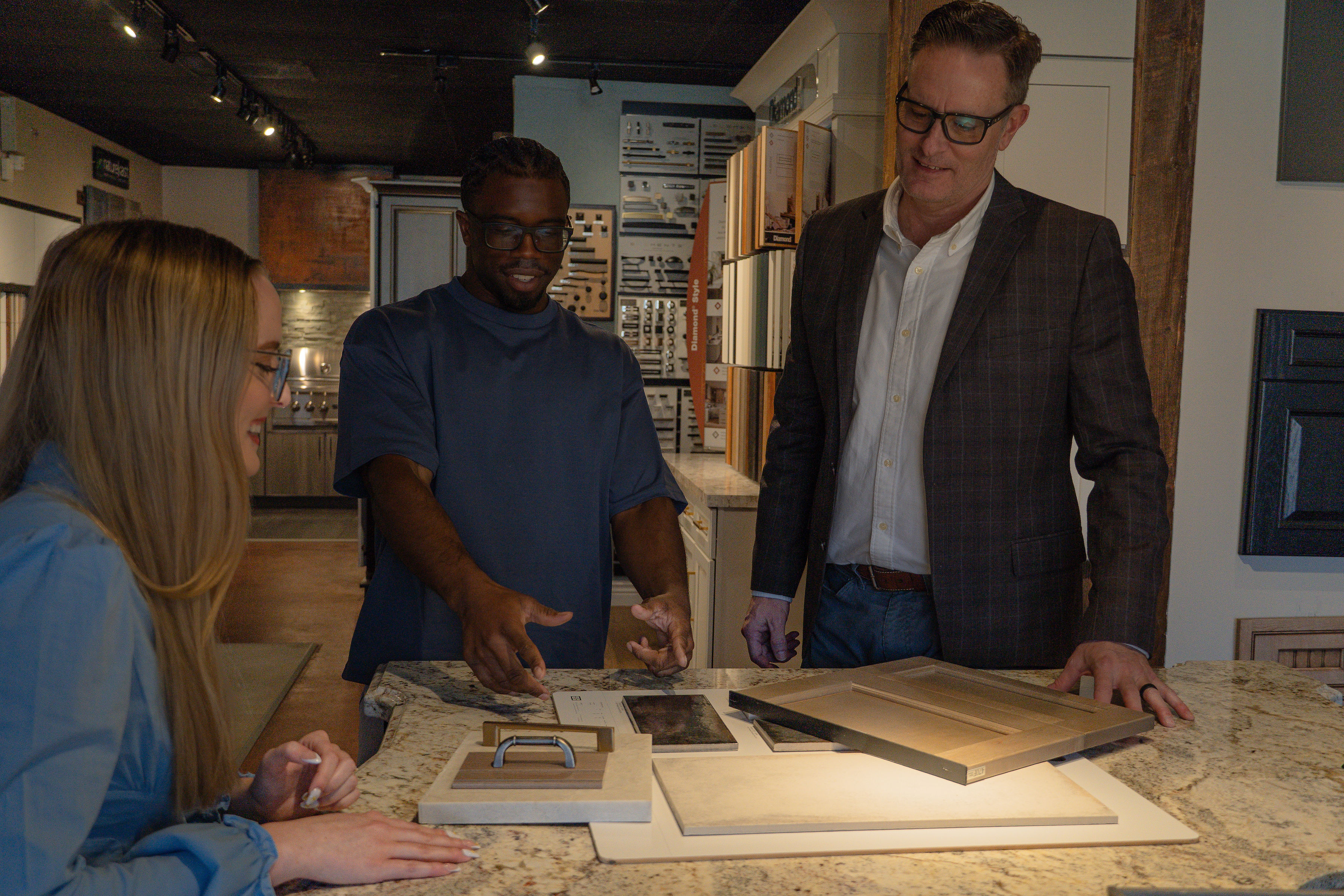Team reviewing cabinet samples in showroom