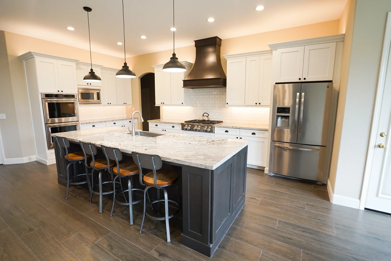 White farmhouse kitchen with dark island