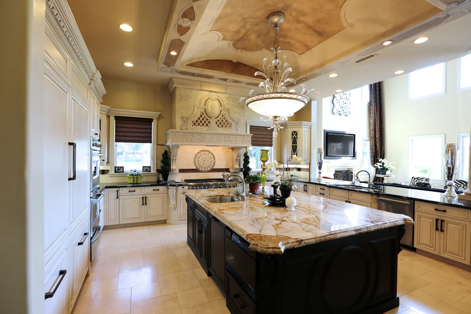 Luxury kitchen with dark island and ornate ceiling