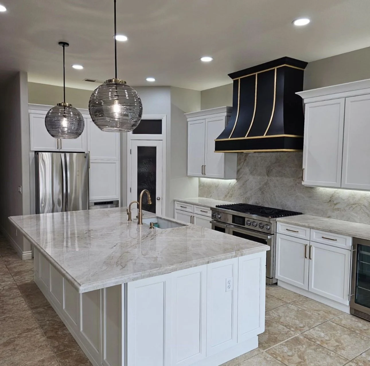 Contemporary white kitchen with globe pendants